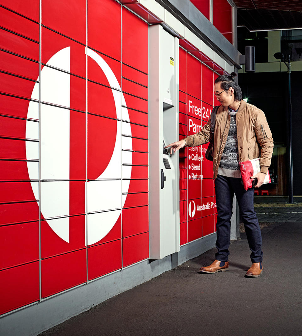 Man holding parcel in front of Australia Post locker. Source: Australia Post