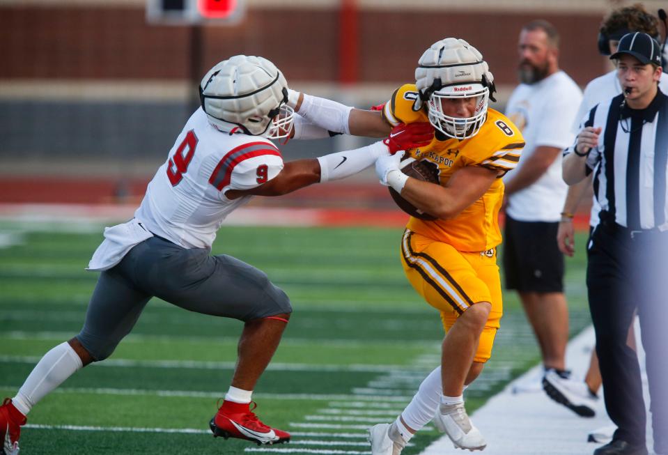 Nixa's Spencer Ward shoves Kickapoo's Noah Harrell out of bounds during Friday's jamboree.