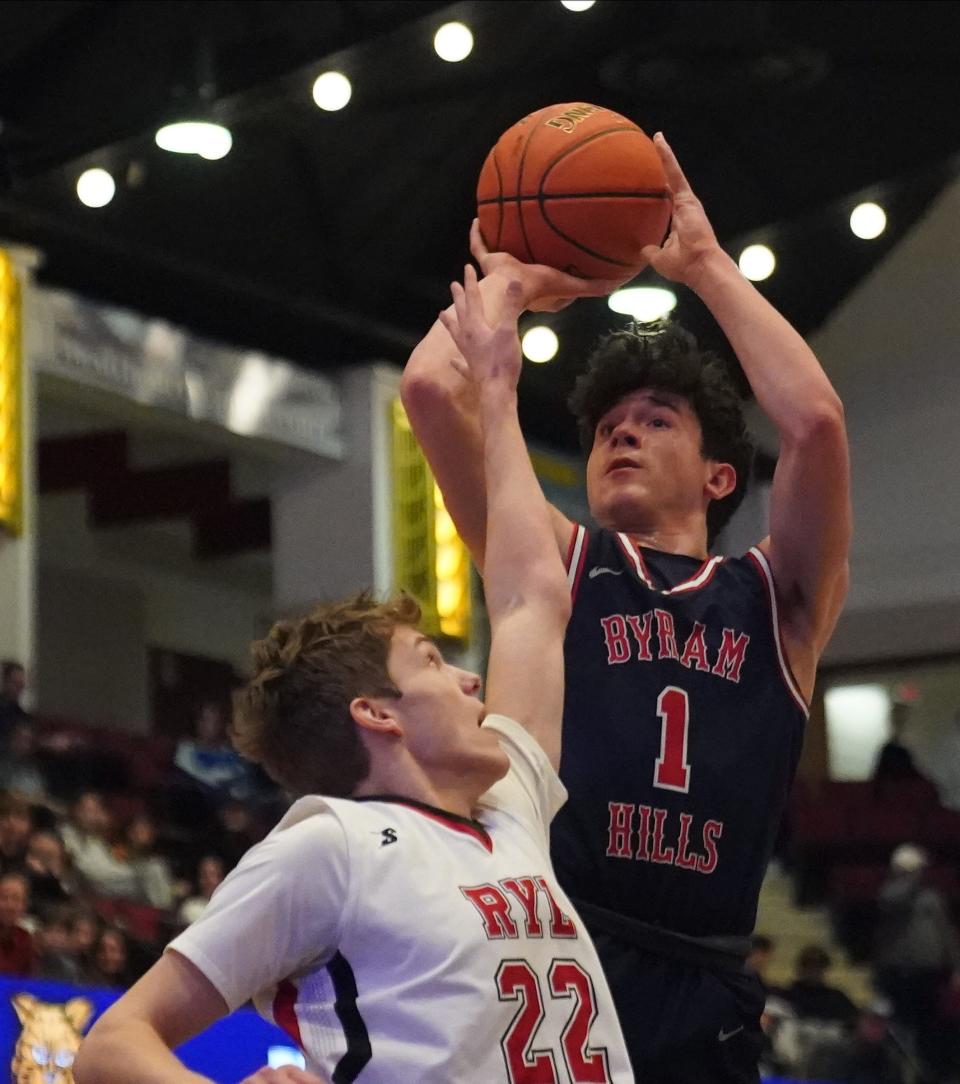 Byram Hills' Chris Amenedo (1) puts a shot over Rye's Rocklan Boisseau (22) in the Section 1 Class A boys basketball championship game at the Westchester County Center in White Plains on Saturday, March 2, 2024.