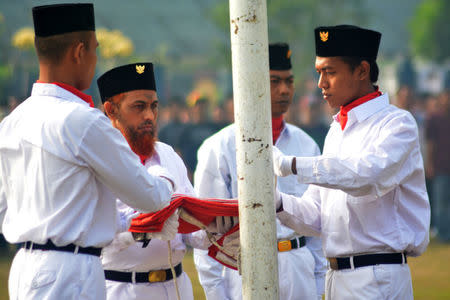 Former Indonesian militant Umar Patek (2nd L), sentenced for his role in the Bali bombings, takes part in a flag-raising ceremony to mark Independence Day in Porong Prison, Sidoarjo, East Java, Indonesia August 17, 2017 in this photo taken by Antara Foto. Antara Foto/Umarul Faruq via REUTERS
