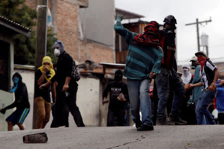 A demonstrator throws stones to the police during a protest against the re-election of Honduras' President Juan Orlando Hernandez in Tegucigalpa, Honduras January 20, 2018. REUTERS/Jorge Cabrera