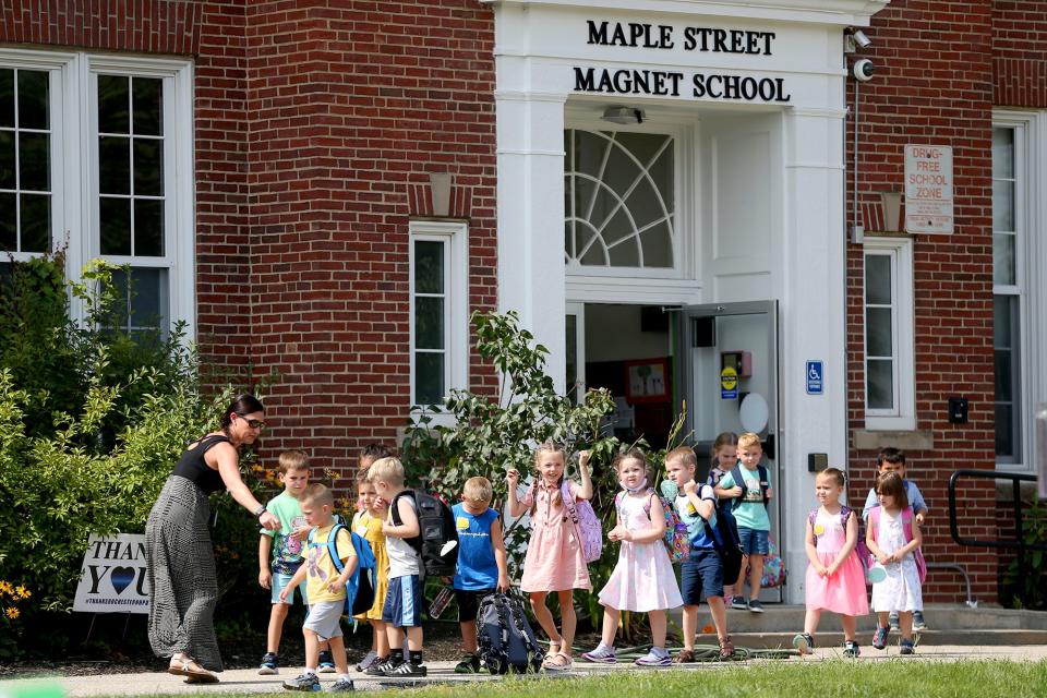 Maple Street Magnet School students walk to buses after their first day of school Monday, Aug. 9, 2021, in Rochester.