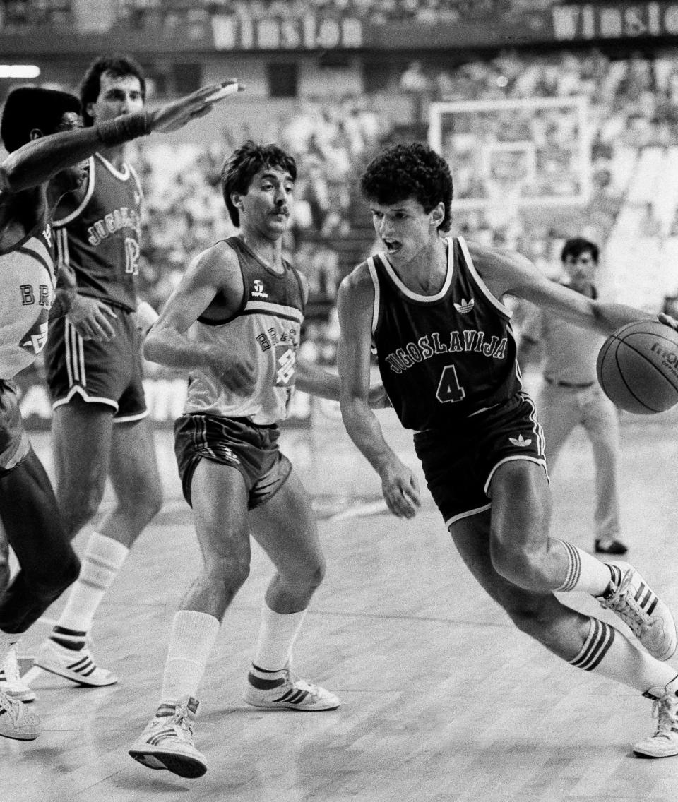 Dražen Petrović drives past Brazil's Rolando Ferreira during the 1986 World Basketball Championship. Vlade Divac and Petrović led Yugoslavia to basketball glory and chased NBA dreams. The war ended their close friendship.