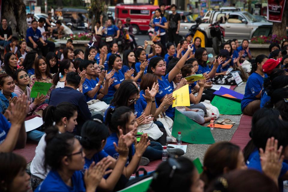 Women applaud at Tha Pae Gate during the annual International Women's Day event.