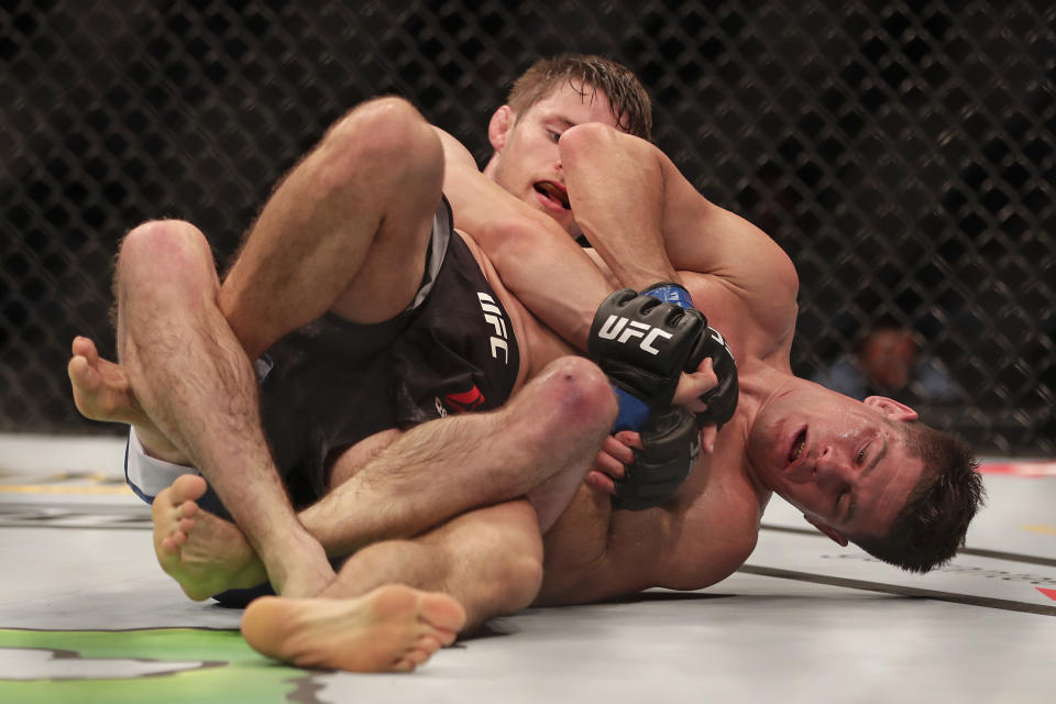 Charles Rosa, right, battles Bryce Mitchell during a UFC 249 mixed martial arts bout Saturday, May 9, 2020, in Jacksonville, Fla. (AP Photo/John Raoux)