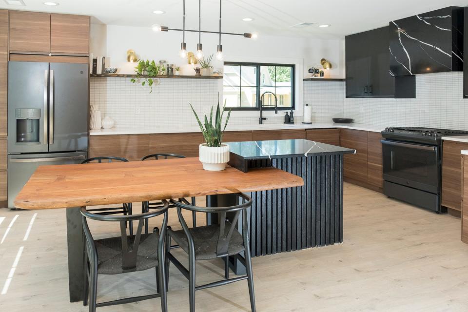 The kitchen is spacious and new with seating that serves as the dining area of the house.