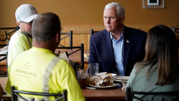 PHOTO: Republican presidential candidate former Vice President Mike Pence talks to local residents during a stop at the Pizza Ranch, on June 8, 2023, in Waukee, Iowa. (Charlie Neibergall/AP)