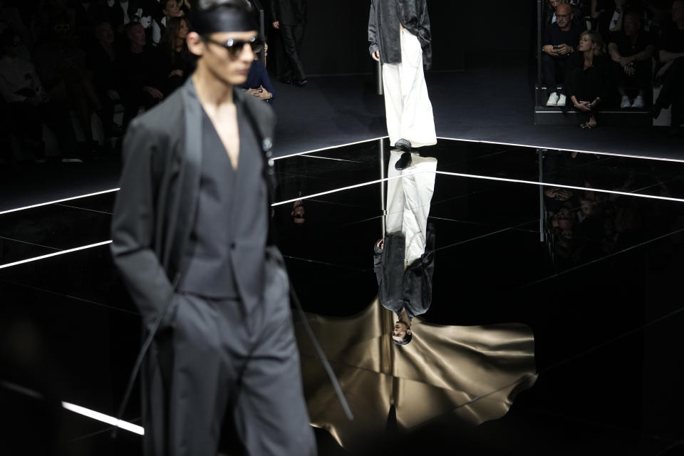 Models wear creations as part of the Emporio Armani men's Spring Summer 2024 collection presented in Milan, Italy, Saturday, June 17, 2023. (AP Photo/Luca Bruno)