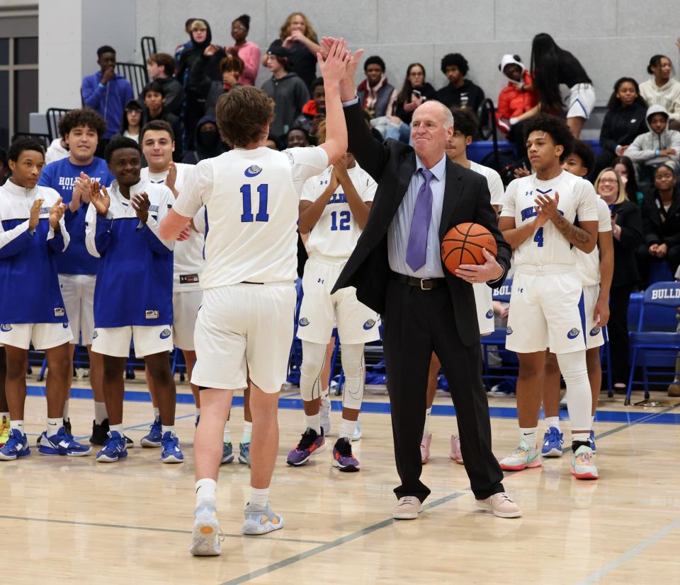 Holbrook's Owen Burke celebrates with coach Rich Gifford after scoring his 1,000th career point during a game against South Shore Christian Academy on Friday, Jan. 13, 2023.