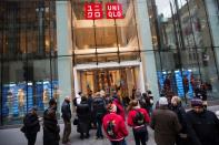 FILE PHOTO: Shoppers line up to wait for the opening of a Uniqlo store in New York