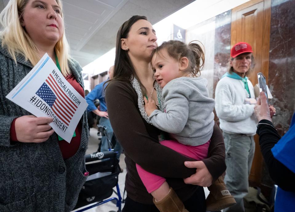 Sarah Myriam of New Jersey holds her daughter Aliyah, 2, as they join activists opposed to vaccinations outside a Senate Health, Education, Labor and Pensions Committee hearing on the safety of vaccines on March 5, 2019.