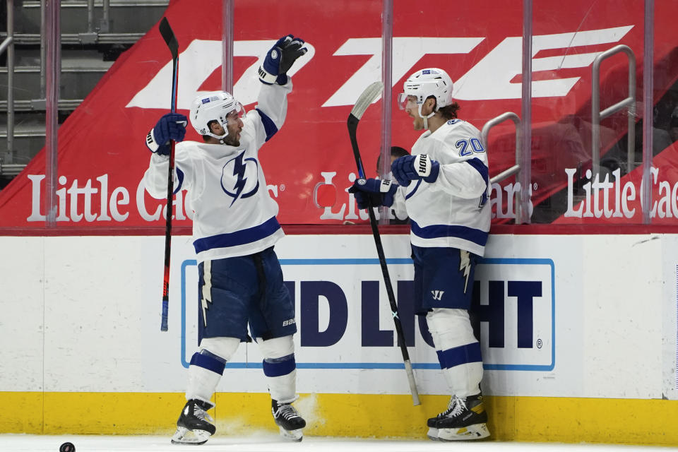 Tampa Bay Lightning center Blake Coleman (20) celebrates his goal with Tyler Johnson during overtime of an NHL hockey game against the Detroit Red Wings Tuesday, March 9, 2021, in Detroit. Tampa Bay won 4-3. (AP Photo/Paul Sancya)