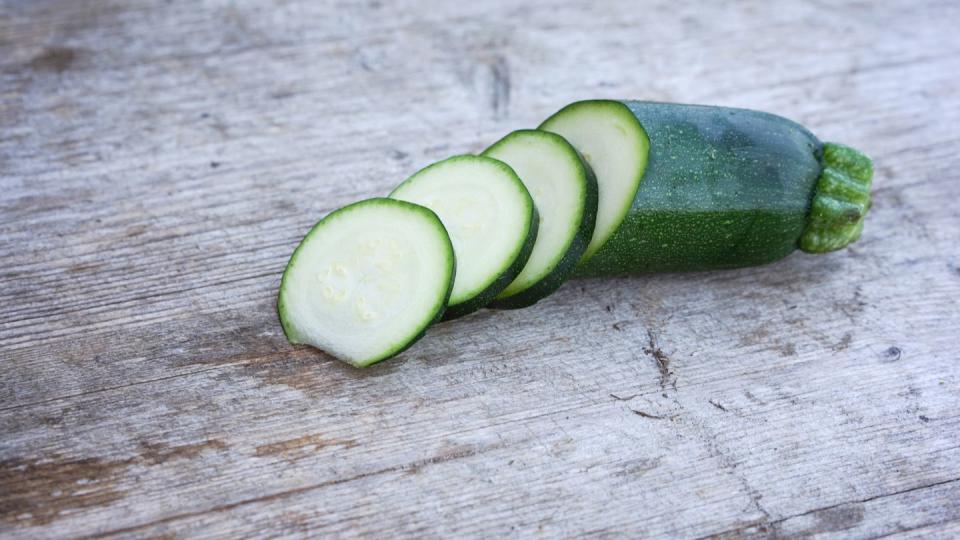 High Angle View Of Zucchini Slices On Wooden Table