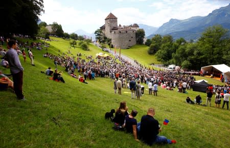 People listen the speech of Hereditary Prince Alois of Liechtenstein in front of Schloss Vaduz castle in Vaduz