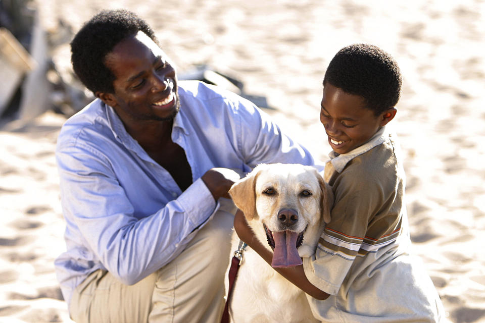 Walt smiling and holding a dog