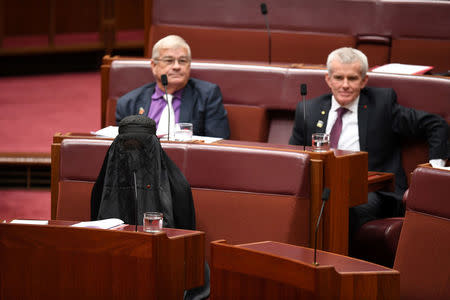 Australian One Nation party leader, Senator Pauline Hanson (L) wears a burqa in the Senate chamber at Parliament House in Canberra, Australia, August 17, 2017. AAP/Mick Tsikas/via REUTERS