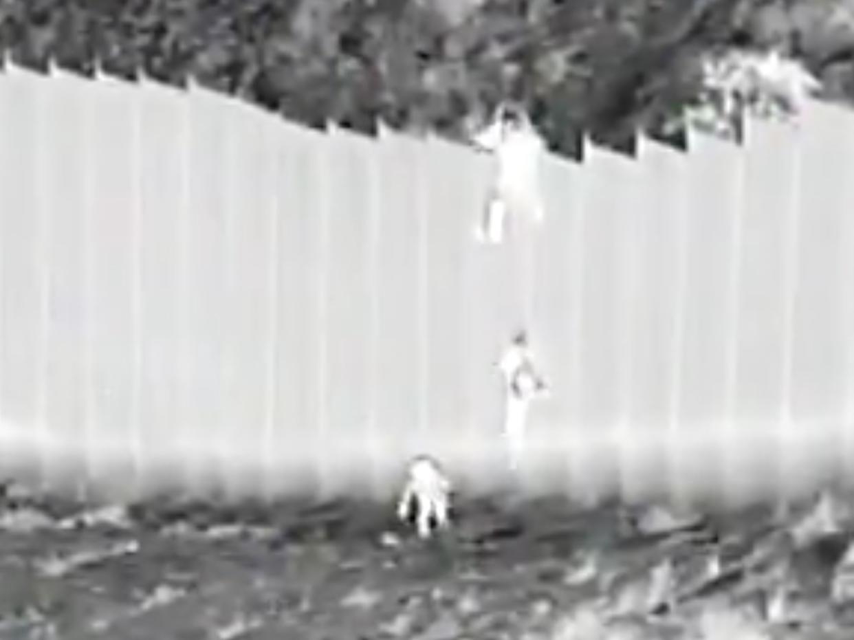 Video captures the moment two young girls were dropped from a 14-foot border wall by smugglers, authorities said.