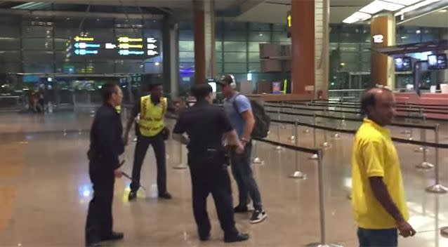 Security guards and members of the public attempt to help the officers detain the man. Photo: Youtube / Ben Bonifant