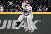 Miami Marlins outfielders from left; Corey Dickerson (23), Starling Marte (6), and Adam Duvall (14) celebrate after defeating the Atlanta Braves in a baseball game Monday, April 12, 2021, in Atlanta. (AP Photo/John Bazemore)