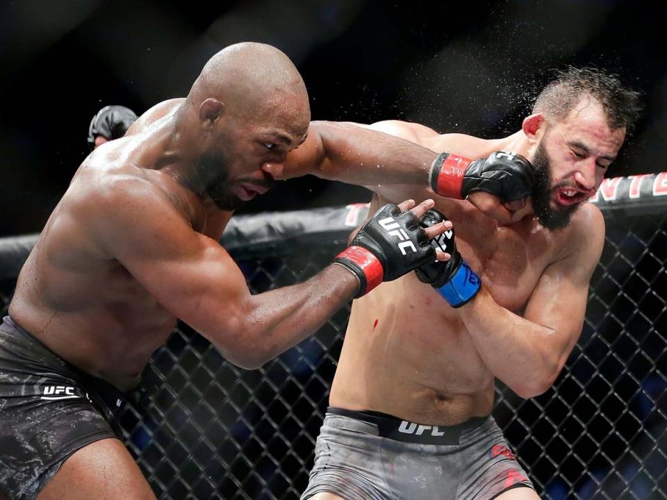 Jon Jones (left) in his most recent fight, a narrow win over Dominick Reyes three years ago (AP)