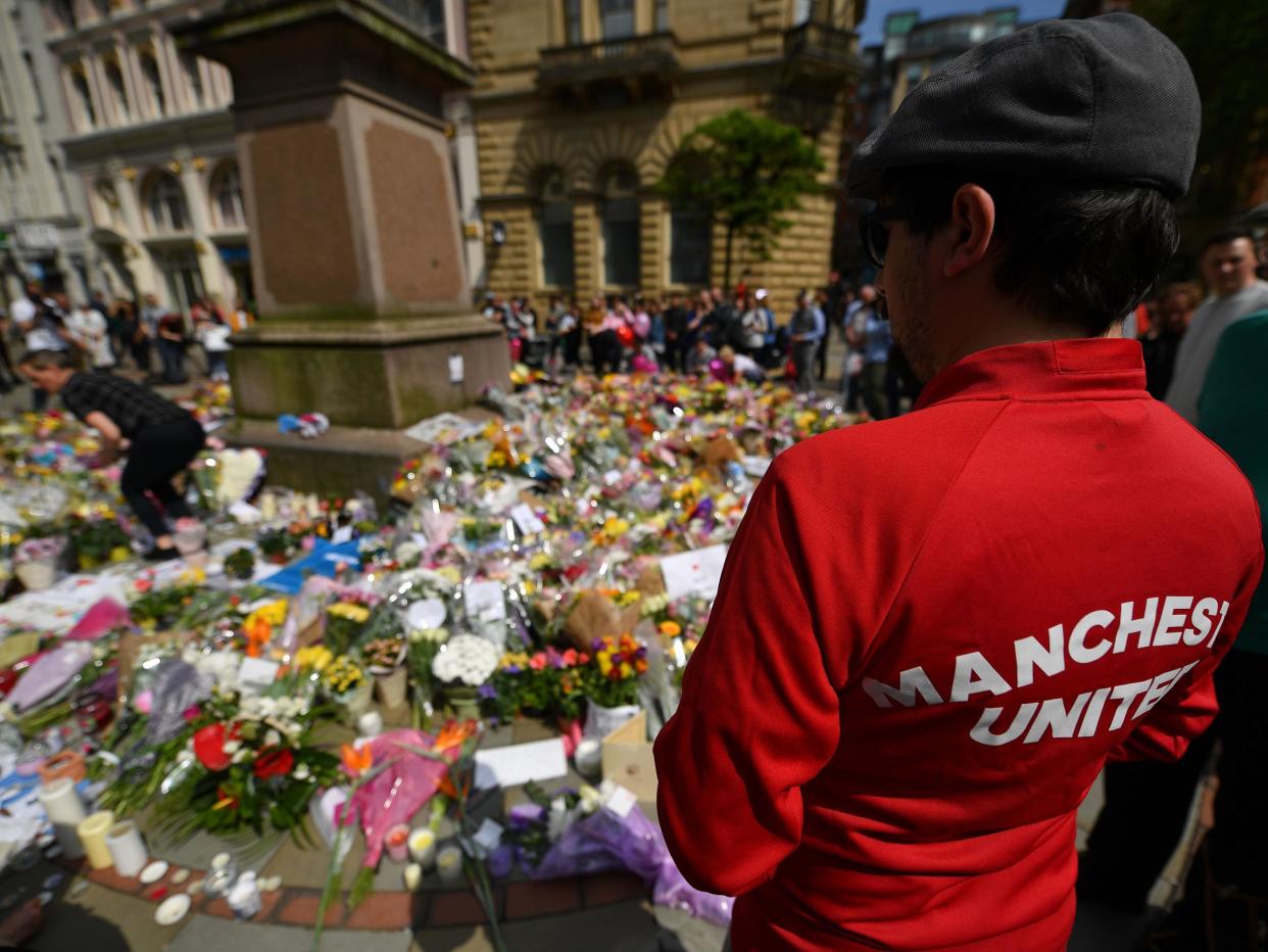 A Manchester United fan pays his respects ahead of kick-off: Getty