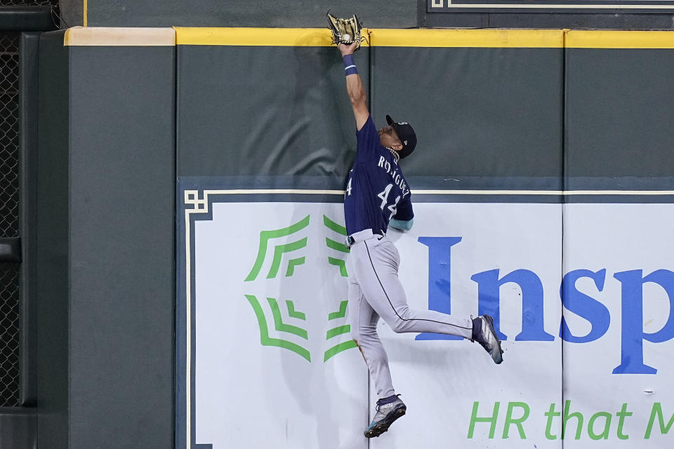 Seattle Mariners center fielder Julio Rodriguez makes a leaping catch at the wall on a fly ball hit by Houston Astros' David Hensley during the ninth inning of a baseball game Friday, July 7, 2023, in Houston. (AP Photo/Kevin M. Cox)