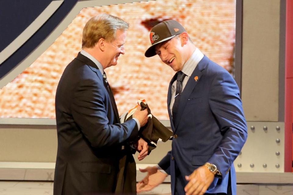 Johnny Manziel hugs NFL Commissioner Roger Goodell after being selected by the Cleveland Browns at the 2014 NFL Draft at Radio City on Thursday, May 8th, 2014 in New York, NY. (AP Photo/Gregory Payan)