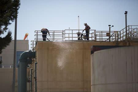 Workers maintain the Edward C. Little Water Recycling Facility during the West Basin Municipal Water District's tour of a water recycling facility in El Segundo, California July 11, 2015. REUTERS/David McNew