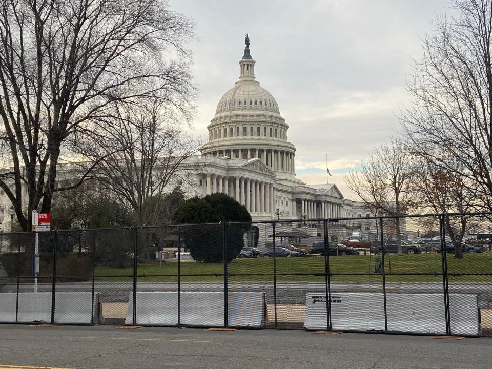 Capitol surrounded by a tall black fence