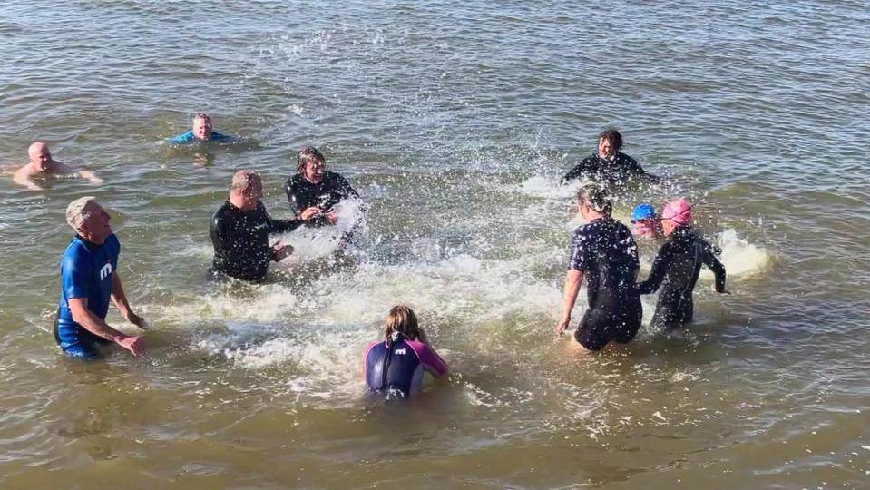 Sir Ed Davey and his campaigners splashing in the sea