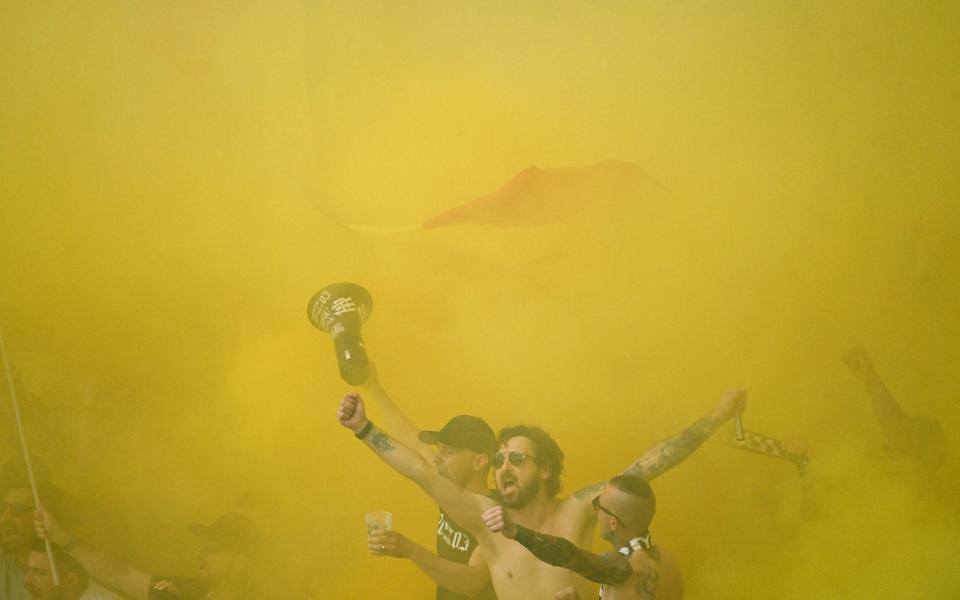 Romania fans turn the air yellow in Frankfurt.