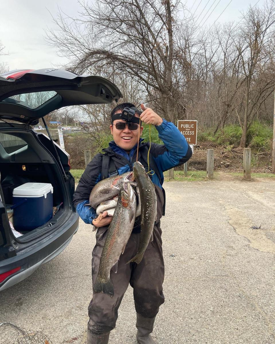 Liu He holds a stringer full of fish. He won 15 Fish of the Year awards from the Indiana Department of Natural Resources in 2022 making him the likely top earner in state history.