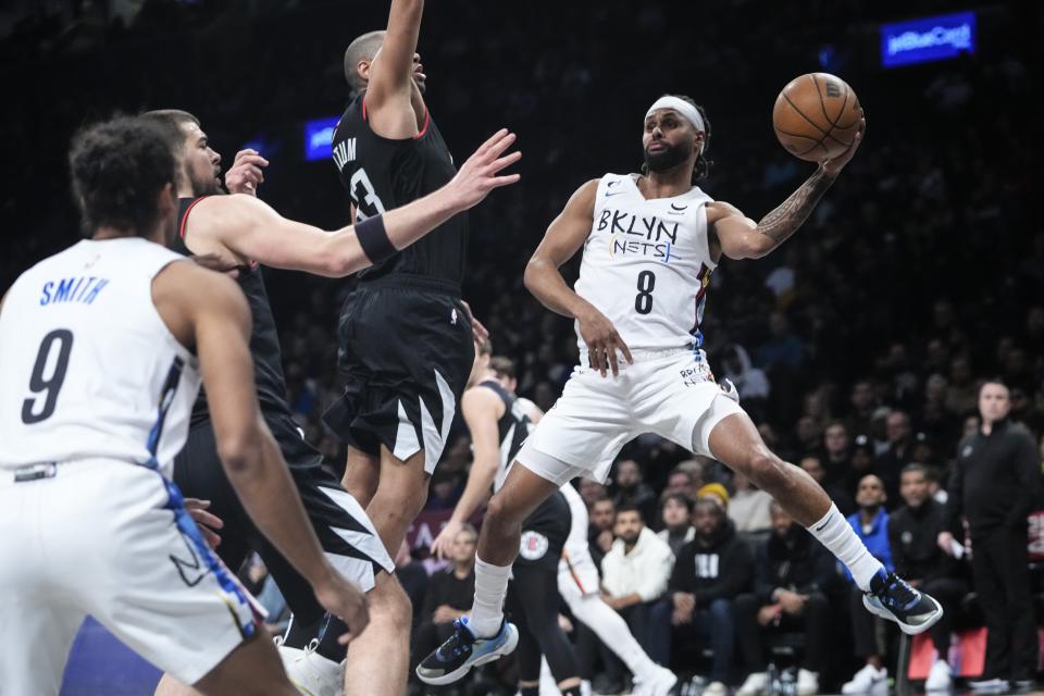 Brooklyn Nets' Patty Mills (8) passes away from Los Angeles Clippers' Nicolas Batum during the first half of an NBA basketball game, Monday, Feb. 6, 2023, in New York. (AP Photo/Frank Franklin II)