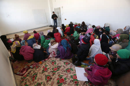 Schoolchildren sit on mats as they attend a class in 'Aisha Mother of the BelieversÕ school which was recently reopened after rebels took control of al-Rai town from Islamic State militants, Syria January 16, 2017. Picture taken January 16, 2017. REUTERS/Khalil Ashawi