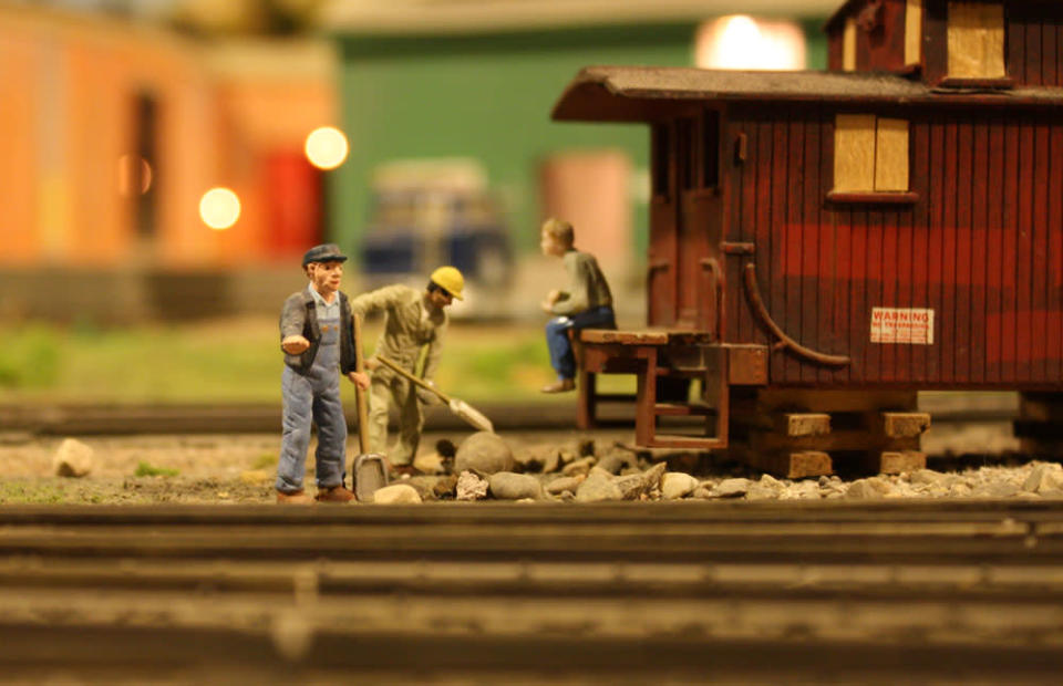 A workers signals for trains to slow down while work is going on. After 67 years in the Liberty Village location, The Model Railroad Club of Toronto will be moving to make way for a condo.