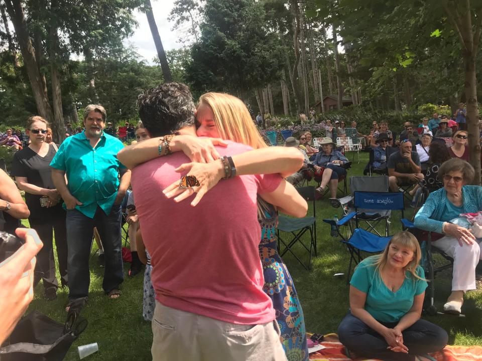 Mark Ristau and Lori Kampa, both of St. Paul, Minn., hug at Munsinger Gardens as a butterfly sits on Kampa's engagement ring.
