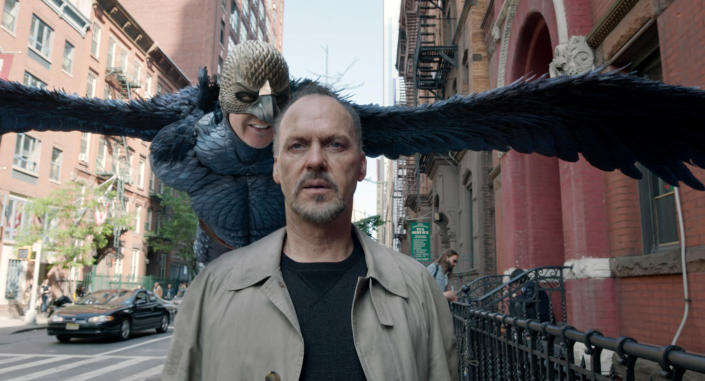 Michael Keaton on the street with his bird character behind him