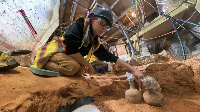 Archaeologist Tess Ostoyich carefully exposes two intact mid-18th century bottles in the Mansion cellar at George Washington’s Mount Vernon. (The Mount Vernon Ladies' Association)