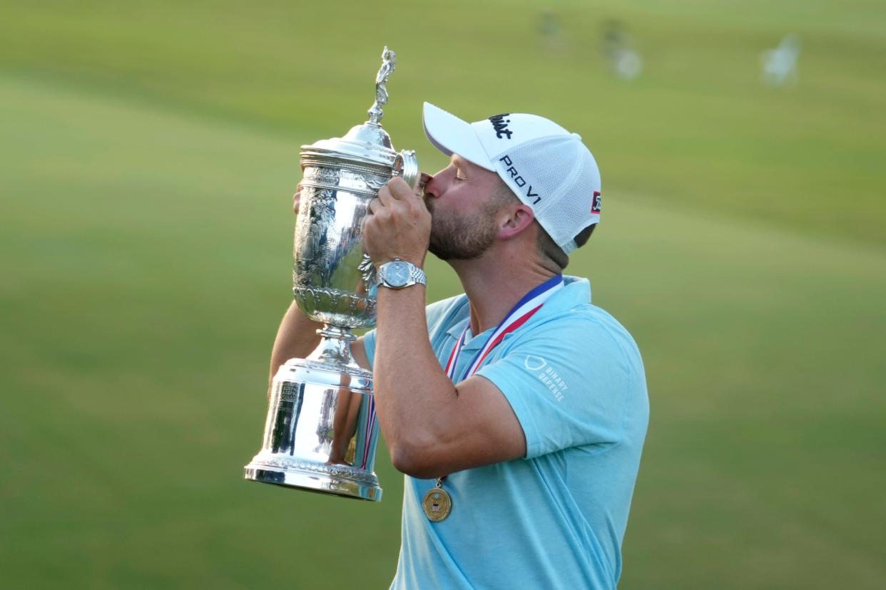 Wyndham Clark kisses the championship trophy after winning the U.S. Open golf tournament at Los Angeles Country Club in June 2023 in Los Angeles.