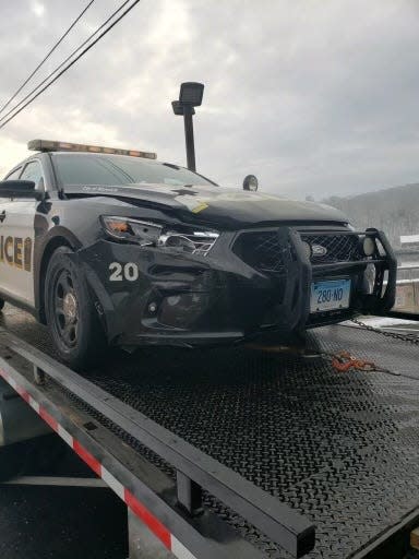 One of two police cruisers damaged in the parking lot off Thames Street Tuesday morning.