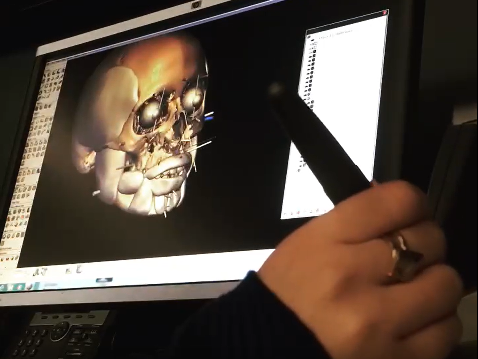 National Center for Missing and Exploited children forensic artist Paloma Galzi uses a stylus-like instrument to create a 3D image of a skull on her computer.