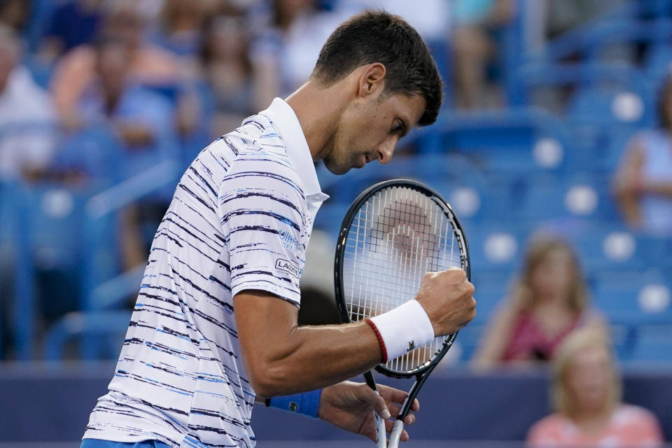 Novak Djokovic, of Serbia, reacts during a match against Pablo Carreno Busta, of Spain, during the quarterfinals of the Western & Southern Open tennis tournament Thursday, Aug. 15, 2019, in Mason, Ohio. (AP Photo/John Minchillo)
