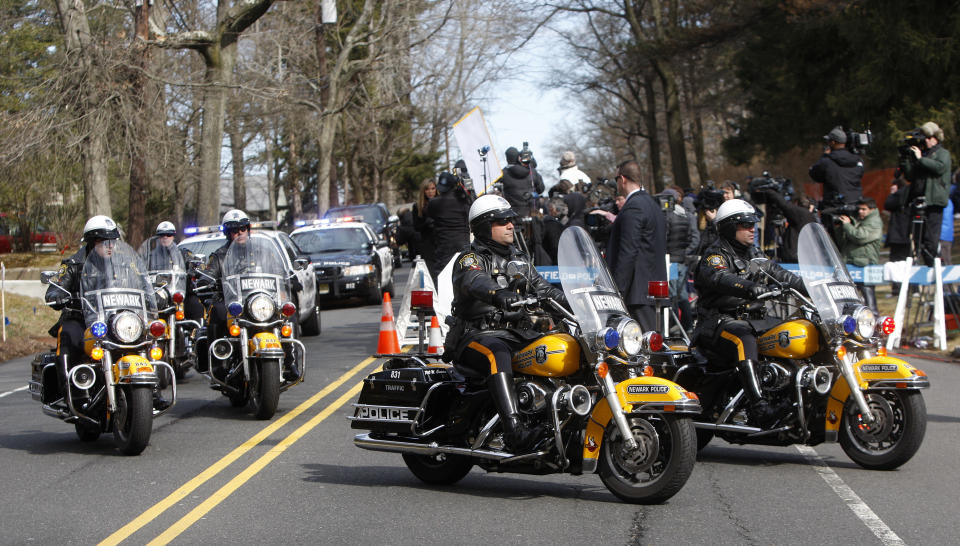 A Newark Police Department motorcade escorts the hearse carrying the body of Whitney Houston arrives at Fairview Cemetery for her burial in Westfield, N.J., Sunday, Feb. 19, 2012. (AP Photo/Rich Schultz)