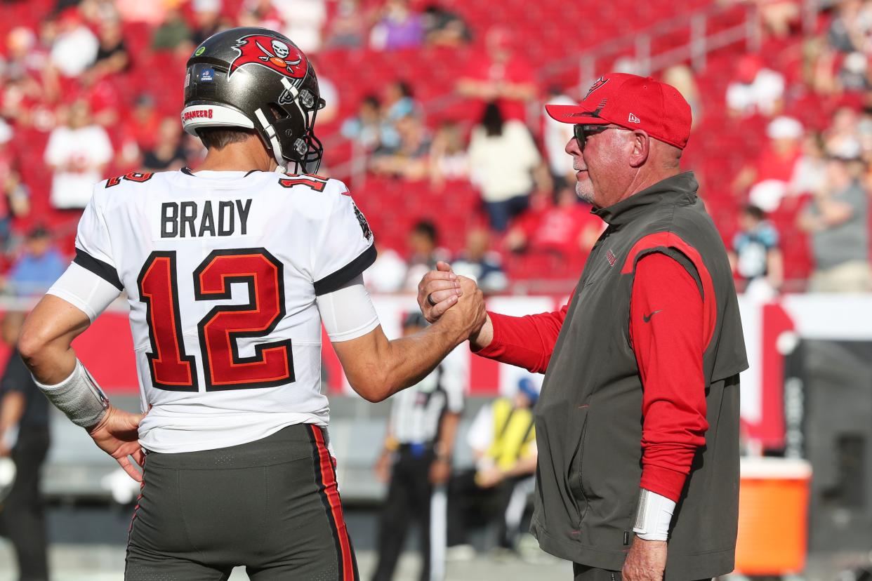 TAMPA, FL - JANUARY 9: Tampa Bay Buccaneers Quarterback Tom Brady (12) greets Head Coach Bruce Arians before the regular season game between the Carolina Panthers and the Tampa Bay Buccaneers on January 9, 2022 at Raymond James Stadium in Tampa, Florida. (Photo by Cliff Welch/Icon Sportswire via Getty Images)