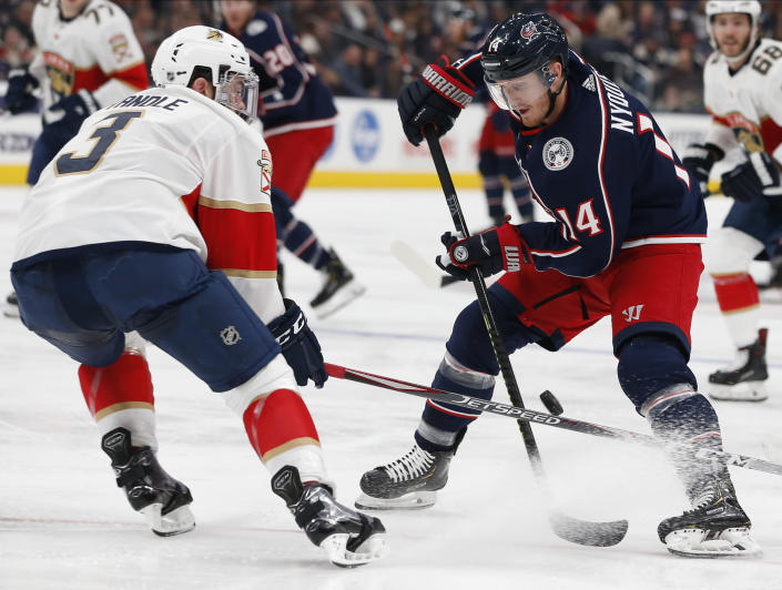 Columbus Blue Jackets' Gustav Nyquist, right, of Sweden, carries the puck up ice as Florida Panthers' Keith Yandle defends during the second period of an NHL hockey game Tuesday, Dec. 31, 2019, in Columbus, Ohio. (AP Photo/Jay LaPrete)