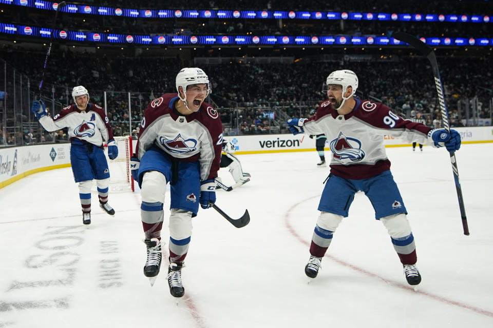 Colorado Avalanche center Ross Colton, center, reacts to scoring against the Seattle Kraken with teammates Mikko Rantanen, left, and Tomas Tatar, right, during the second period of an NHL hockey game, Monday, Nov. 13, 2023, in Seattle. (AP Photo/Lindsey Wasson)