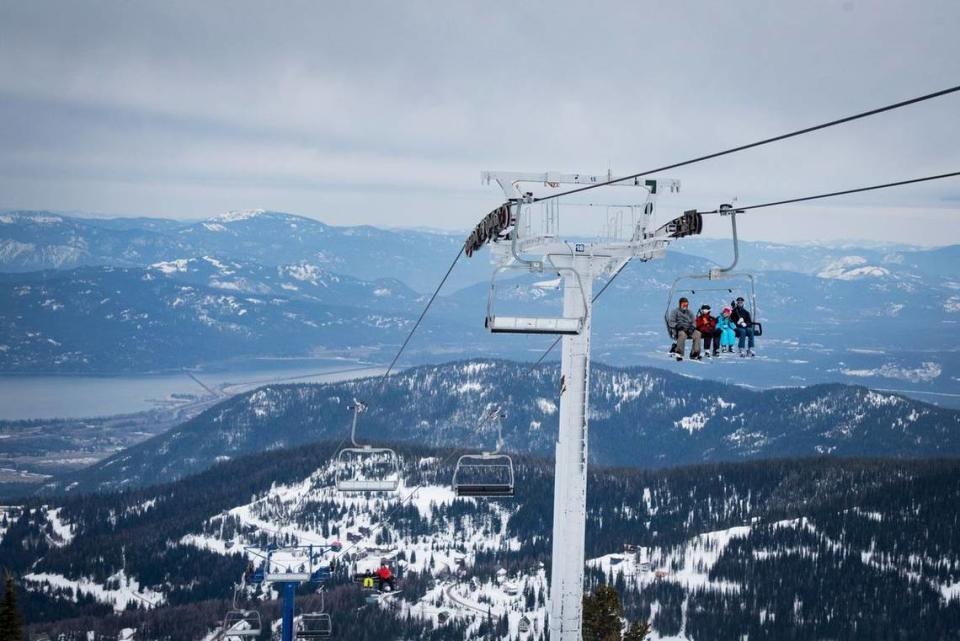 Skiers ride up Schweitzer Mountain’s Great Escape quad chair.