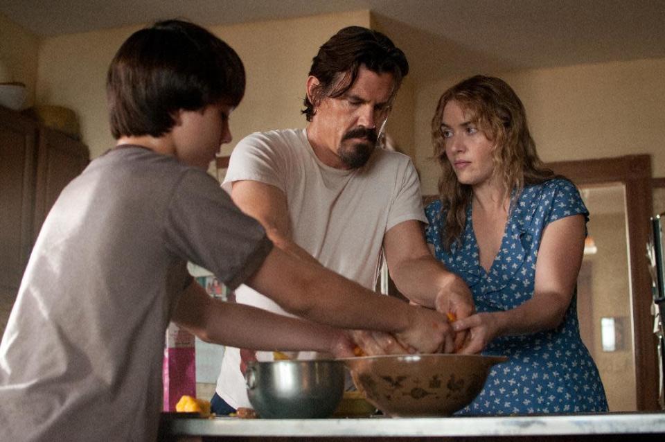 This image released by Paramount Pictures shows Gattlin Griffith, left, Josh Brolin and Kate Winslet in a scene from "Labor Day." (AP Photo/Paramount Pictures, Dale Robinette)