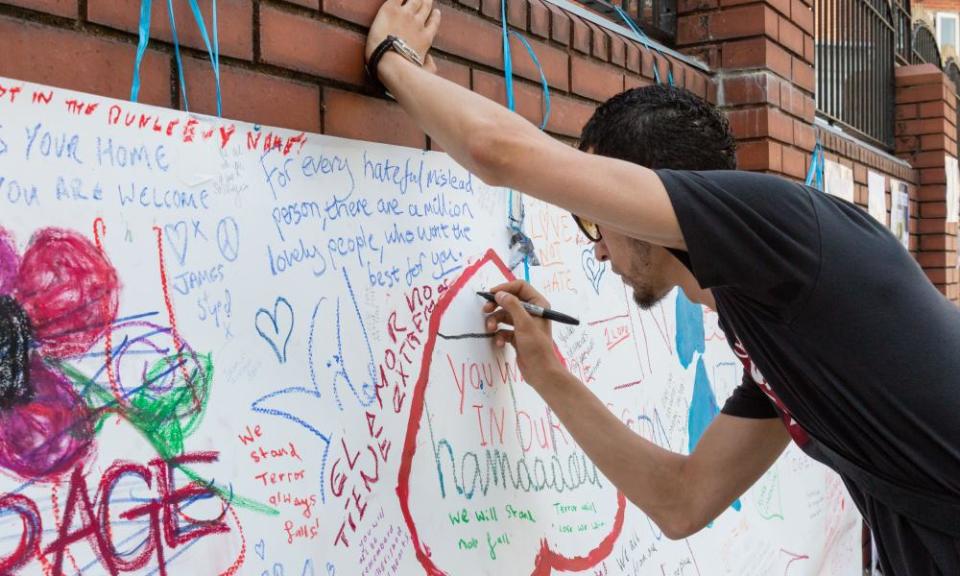 Wellwishers write on a banner outside Finsbury Park mosque after the attack on Monday.