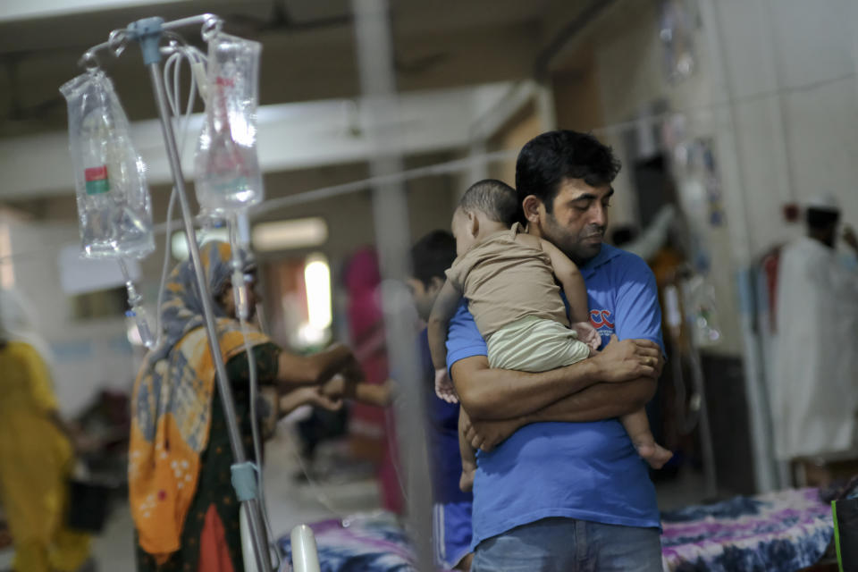 A man comforts his child suffering from dengue at Mugda Medical College and Hospital in Dhaka, Bangladesh, Thursday, Sept. 14, 2023. Bangladesh is struggling with a record outbreak of dengue fever, with experts saying a lack of a coordinated response is causing more deaths from the mosquito-transmitted disease. (AP Photo/Mahmud Hossain Opu)